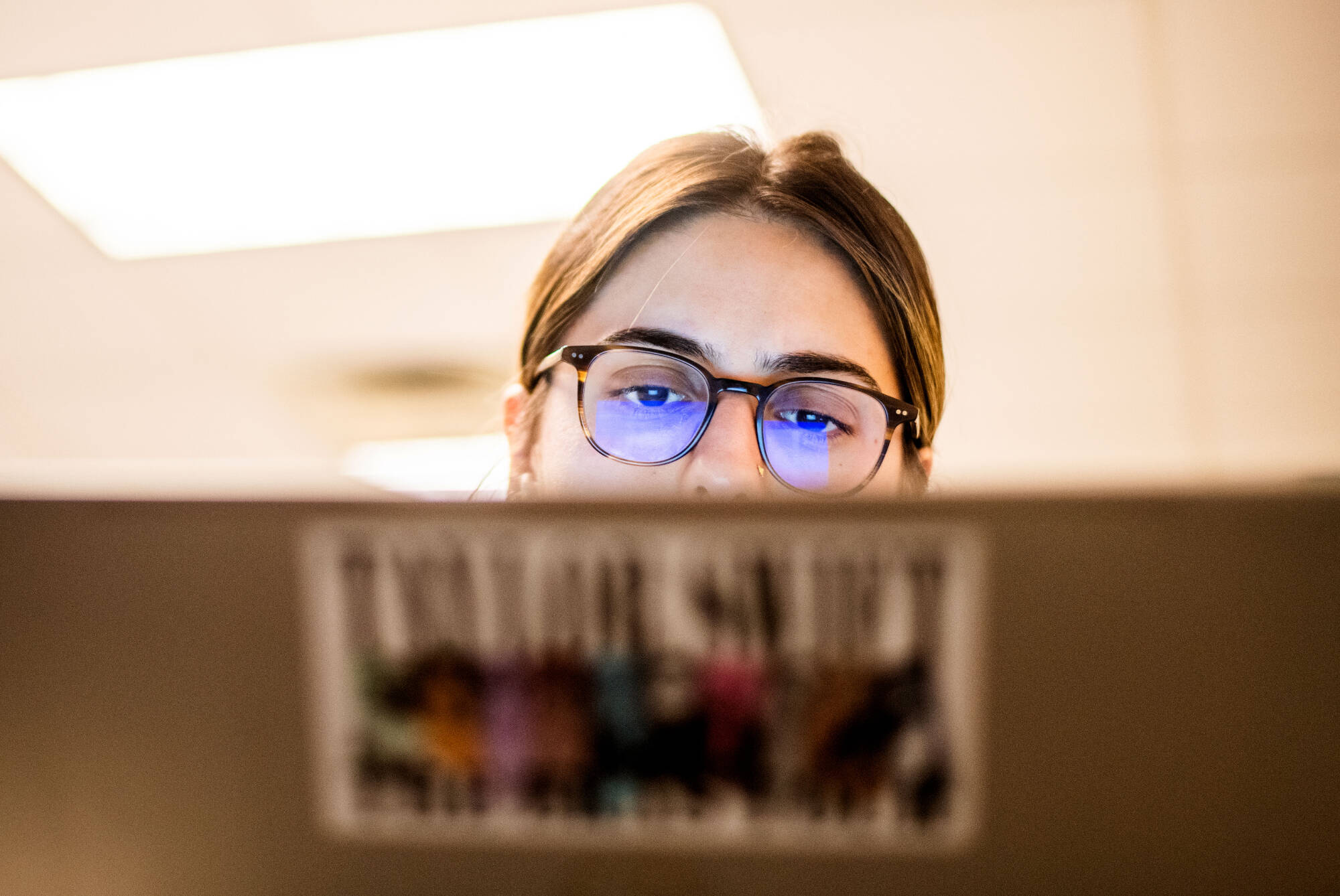 Natalie Aguirre works on her laptop during class. Aguirre’s professor, Alisha Karabinus, uses AI tools in her writing and digital studies classes.